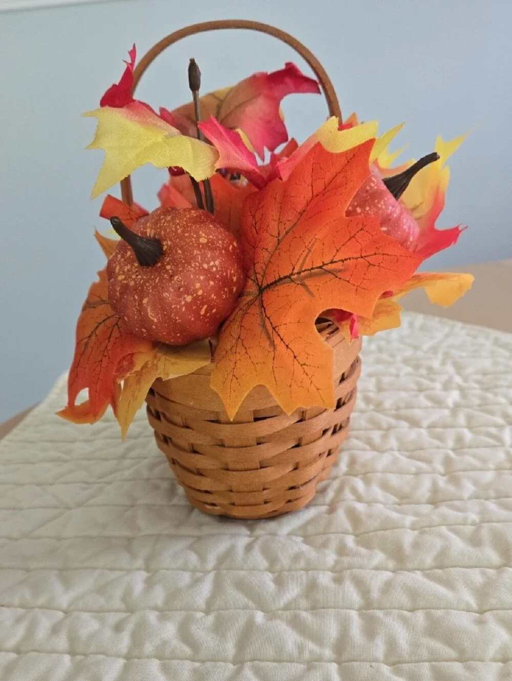 Longaberger woven basket with orange and yellow fall foliage
